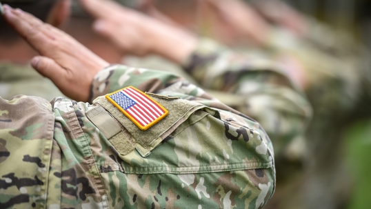 A soldier saluting the flag