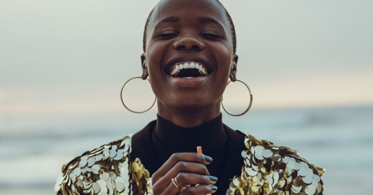 A woman standing and smiling with joy