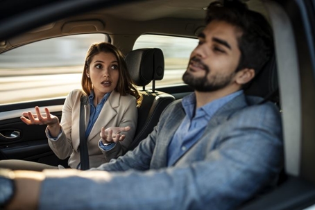 working couple arguing while driving