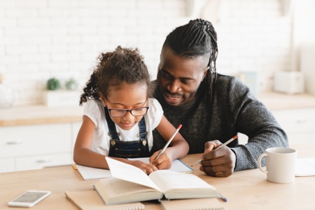 Father helping daughter with homework