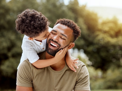 son kissing father on the cheek