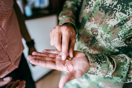 servicemember holding wedding ring