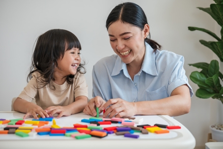 mother and daughter playing with puzzles
